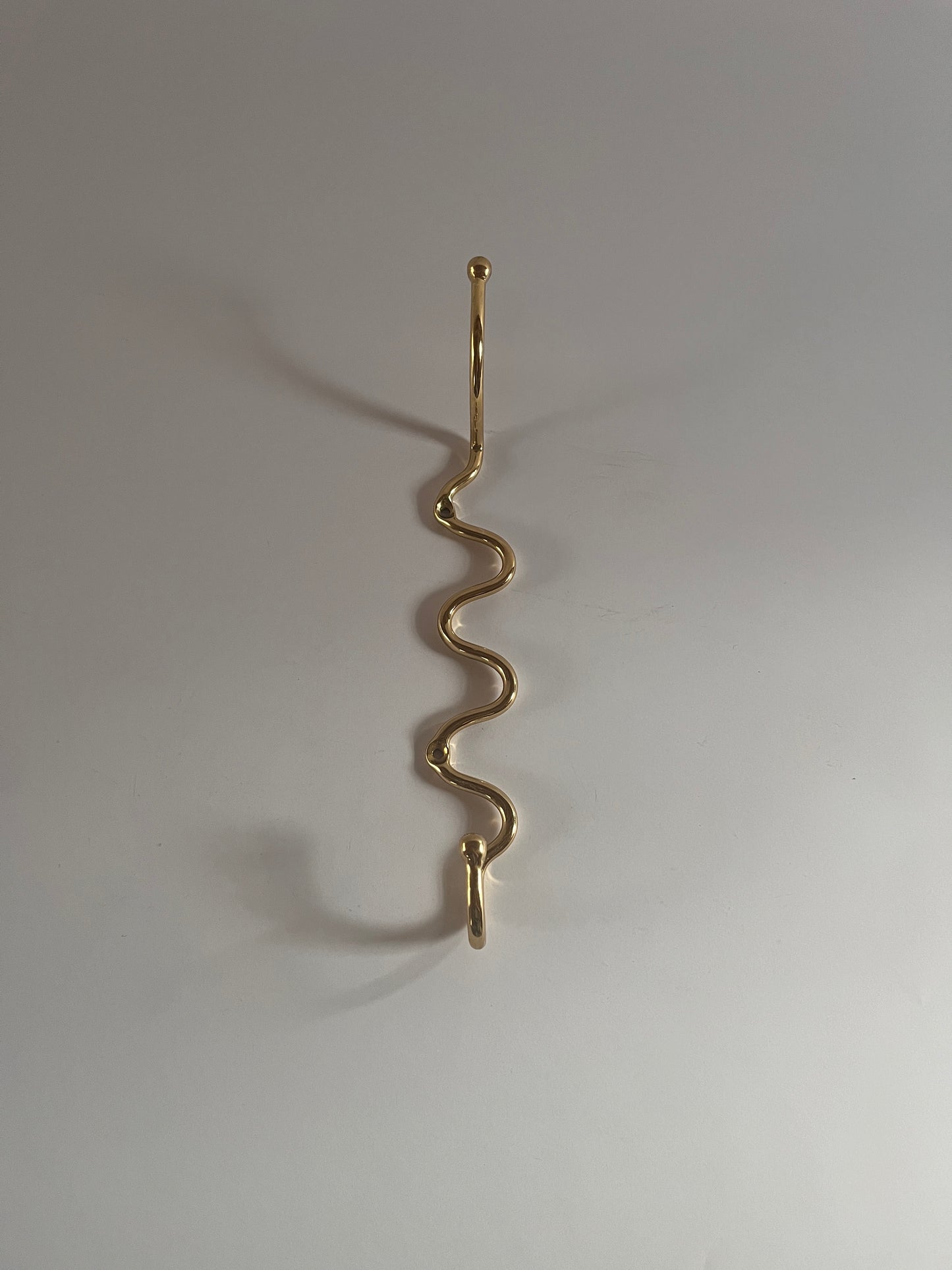 Wiggle hook in solid brass similar to a squiggle hook or curvature hook