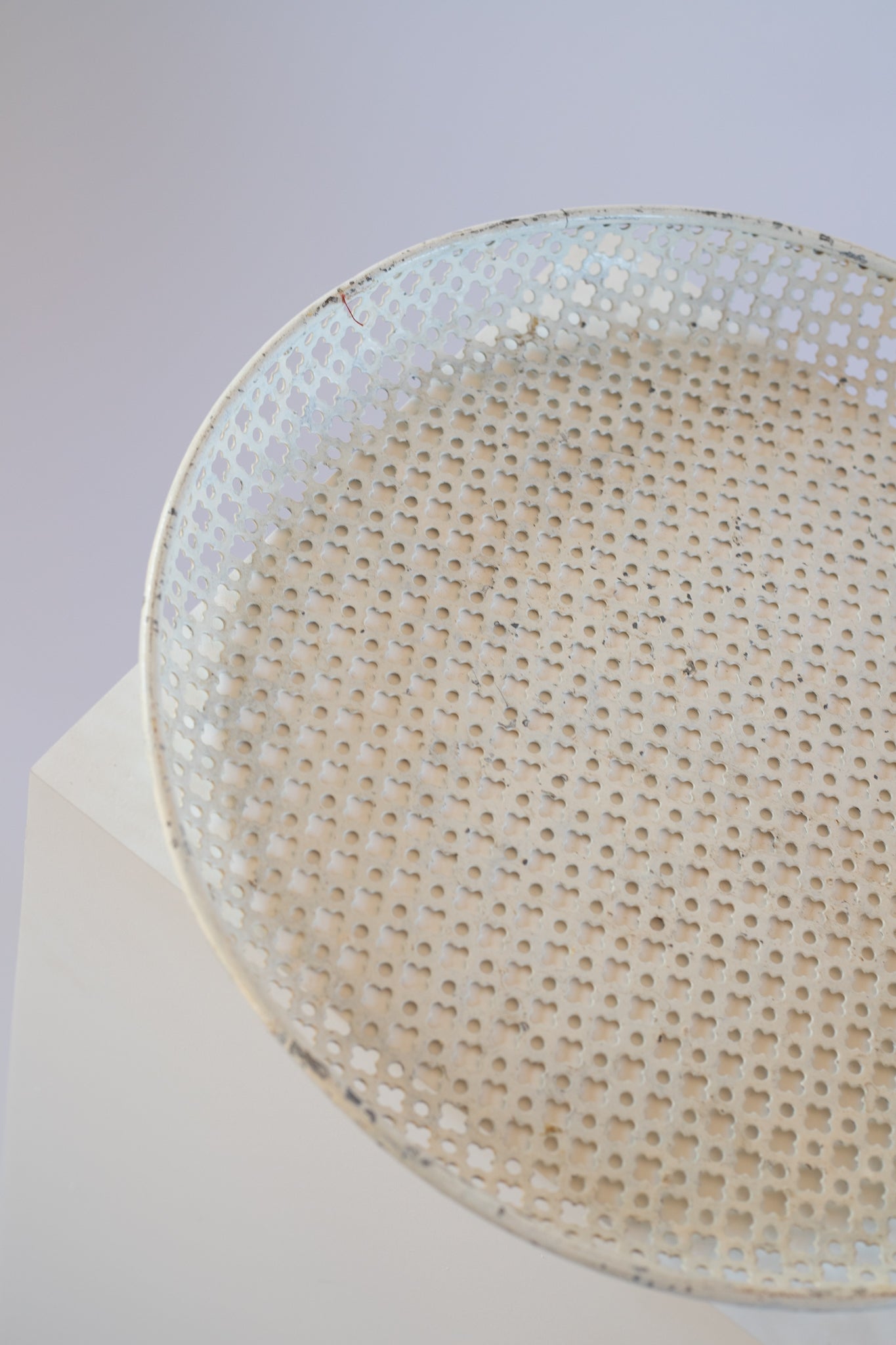 cream metal tray on light grey background