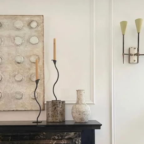 Iron wavy wiggle candleholders and candlesticks shown on a mantelpiece 