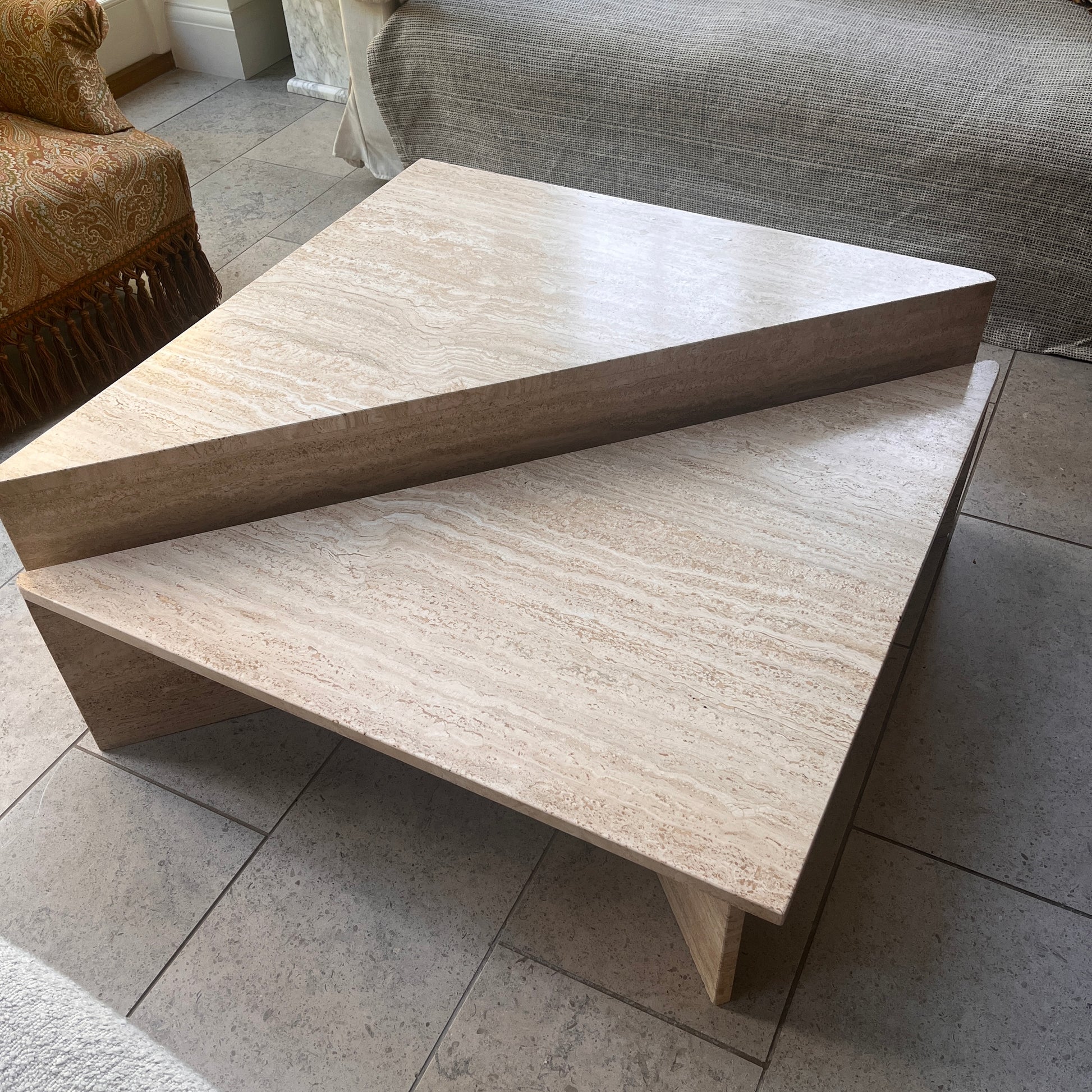 Beige stone coffee table in a living room setting. Made from travertine Italian by Up&UP. Vintage marble table