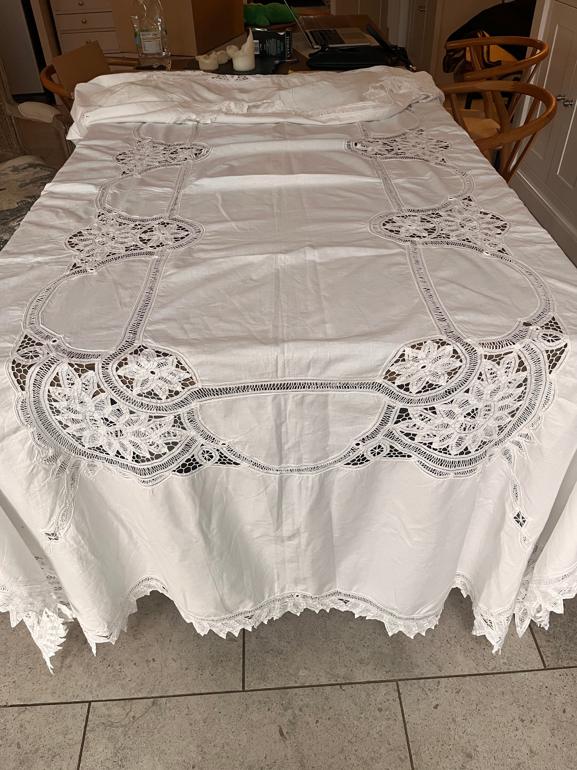 White lace tablecloth on a tiled floor