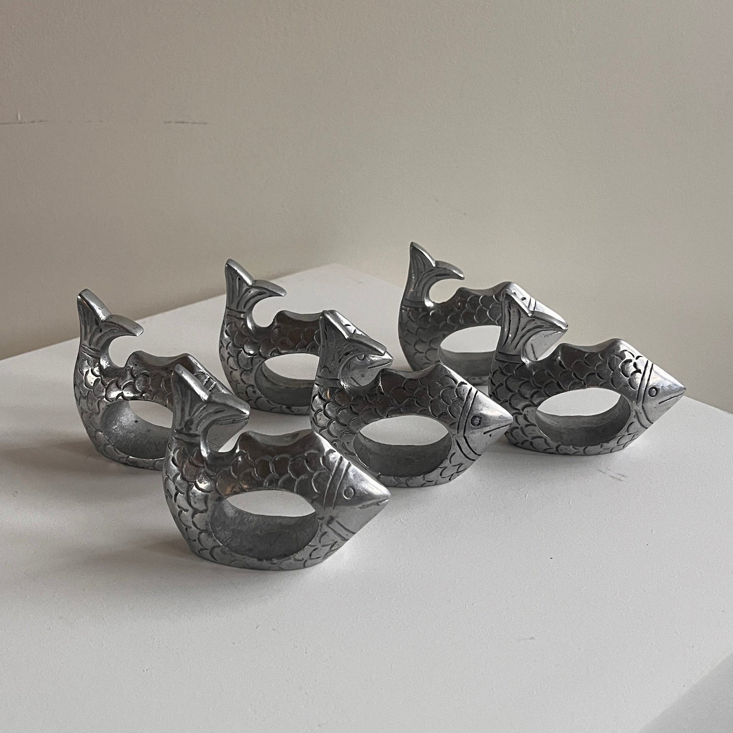 Metallic decorative wall piece on a plain background