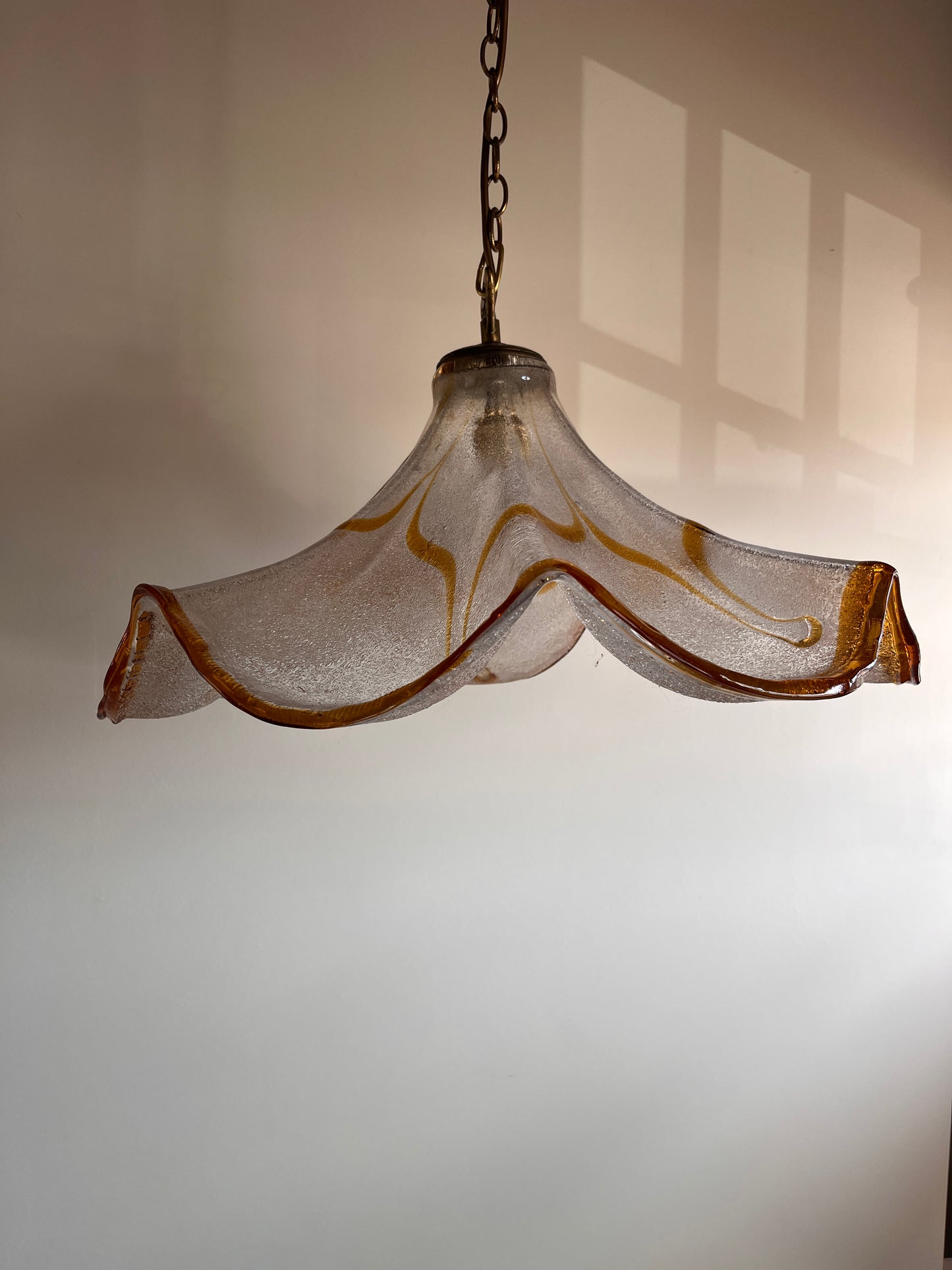 Large Murano glass pendant light with amber graniglia texture and wavy silhouette, circa 1970