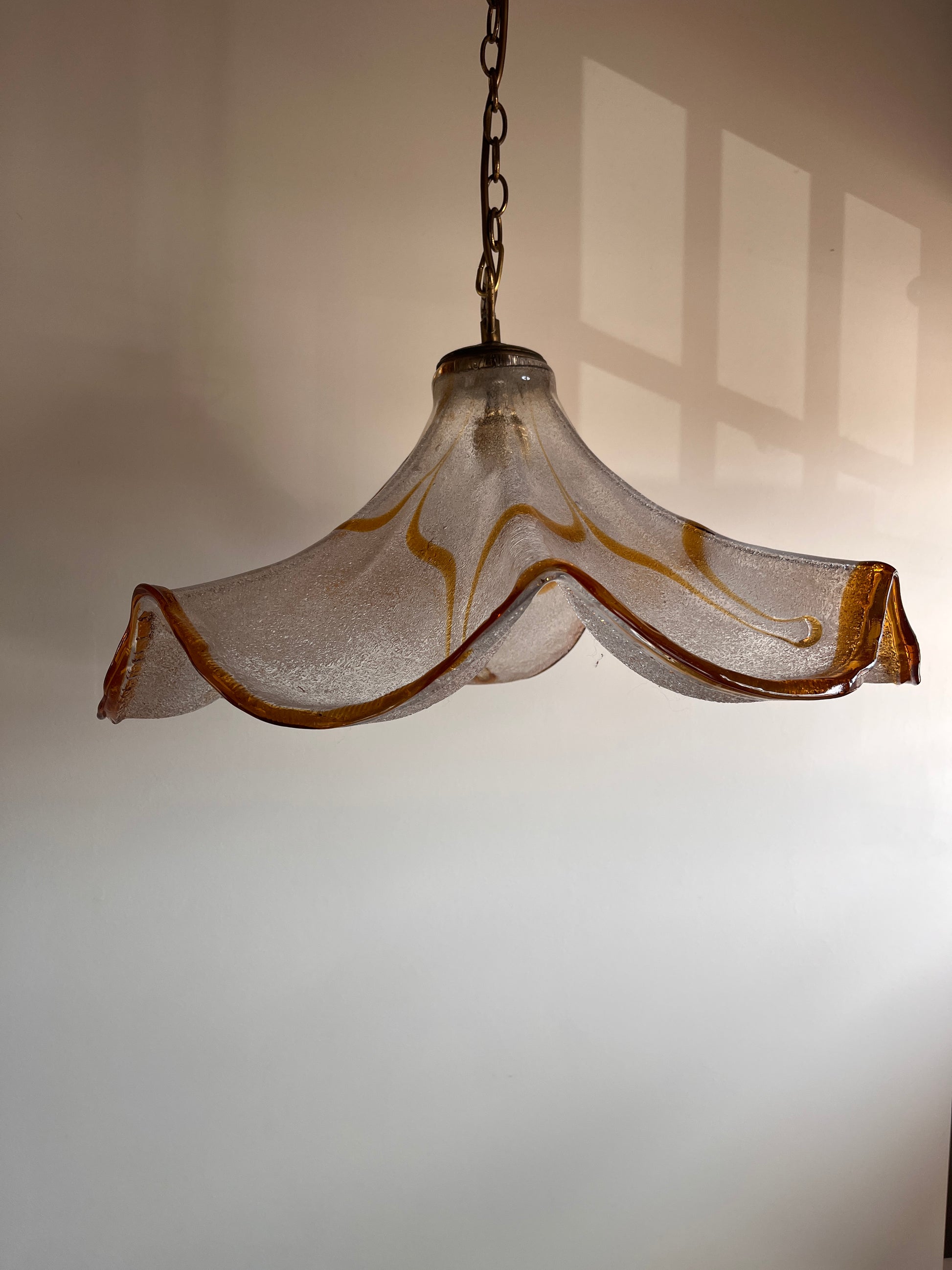 Large Murano glass pendant light with amber graniglia texture and wavy silhouette, circa 1970
