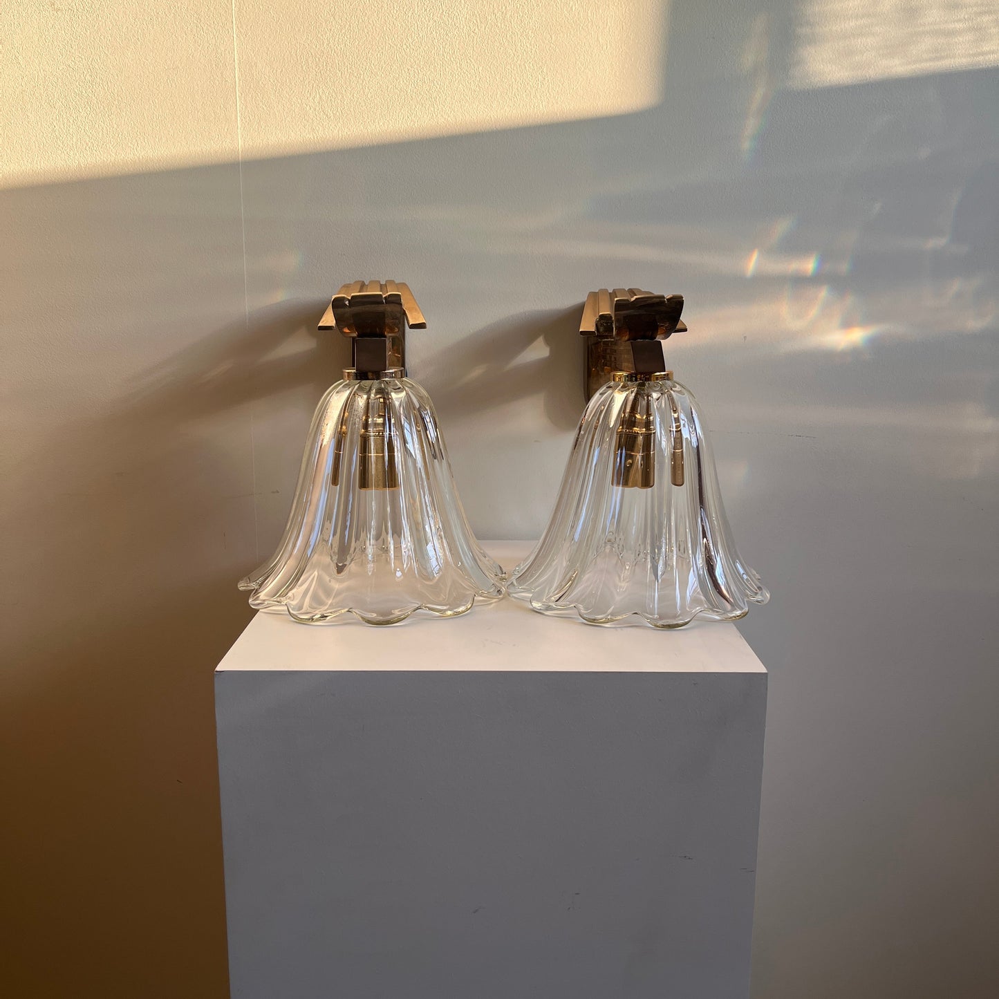 Clear glass bottle with gold cap on a white surface