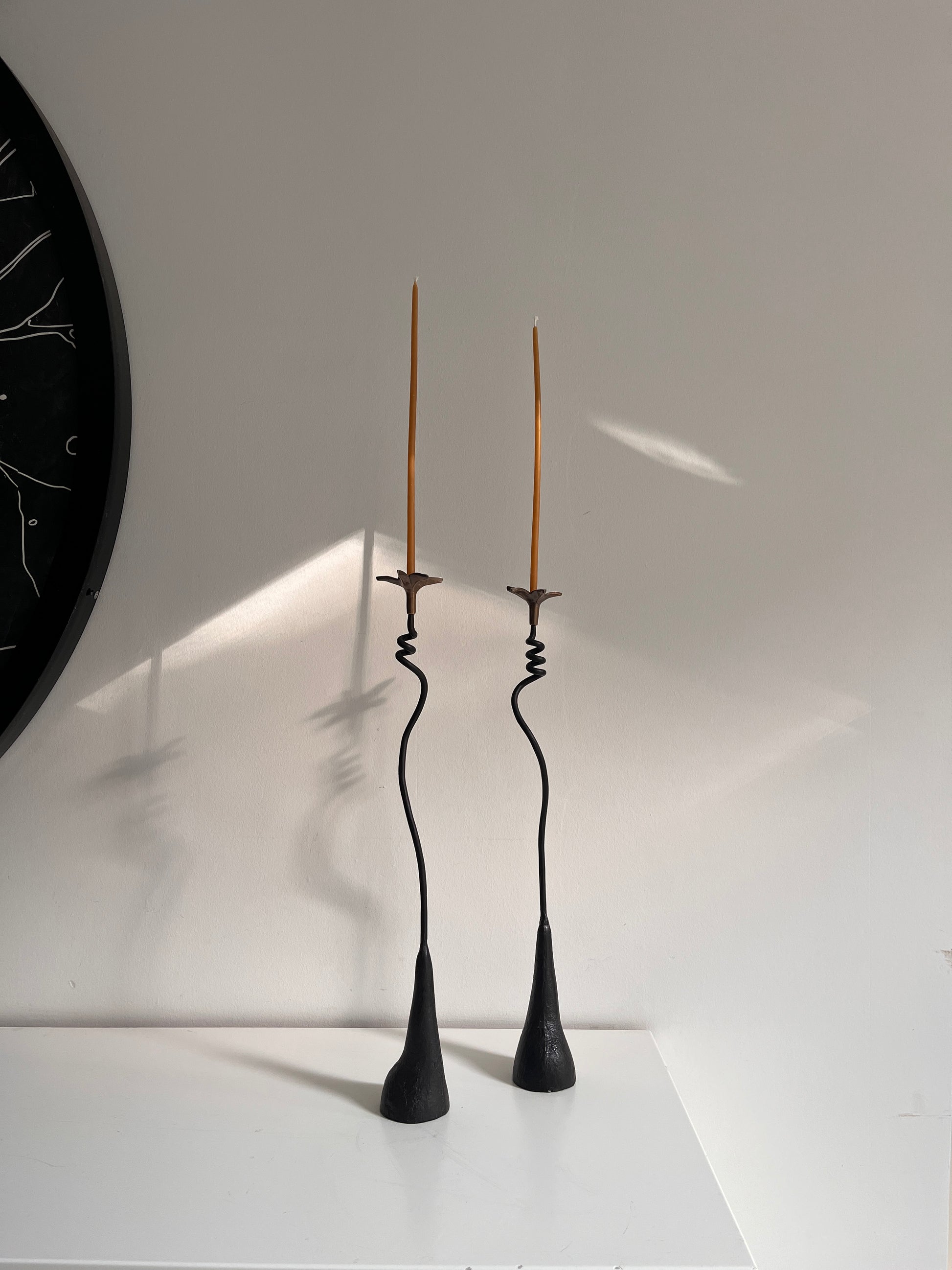 Tall sculptural US made iron candleholders with brass flower on top