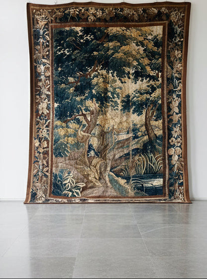 Decorative antique Aubusson vedure tapestry with nature scene on a plain wall 