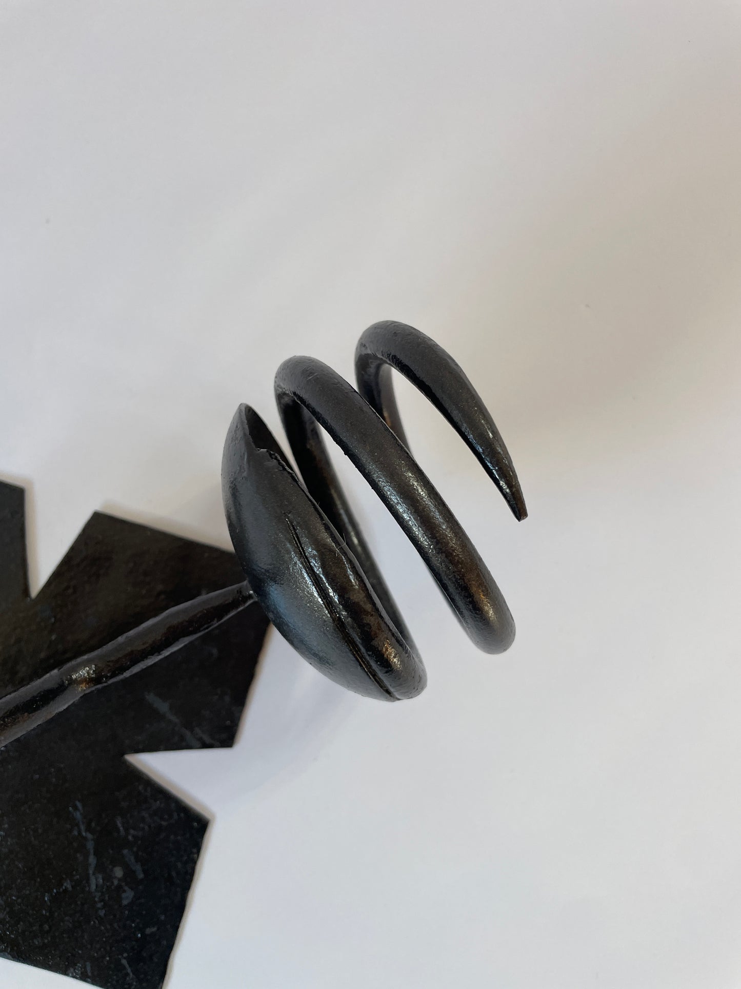 pair of black iron sconces on light grey background