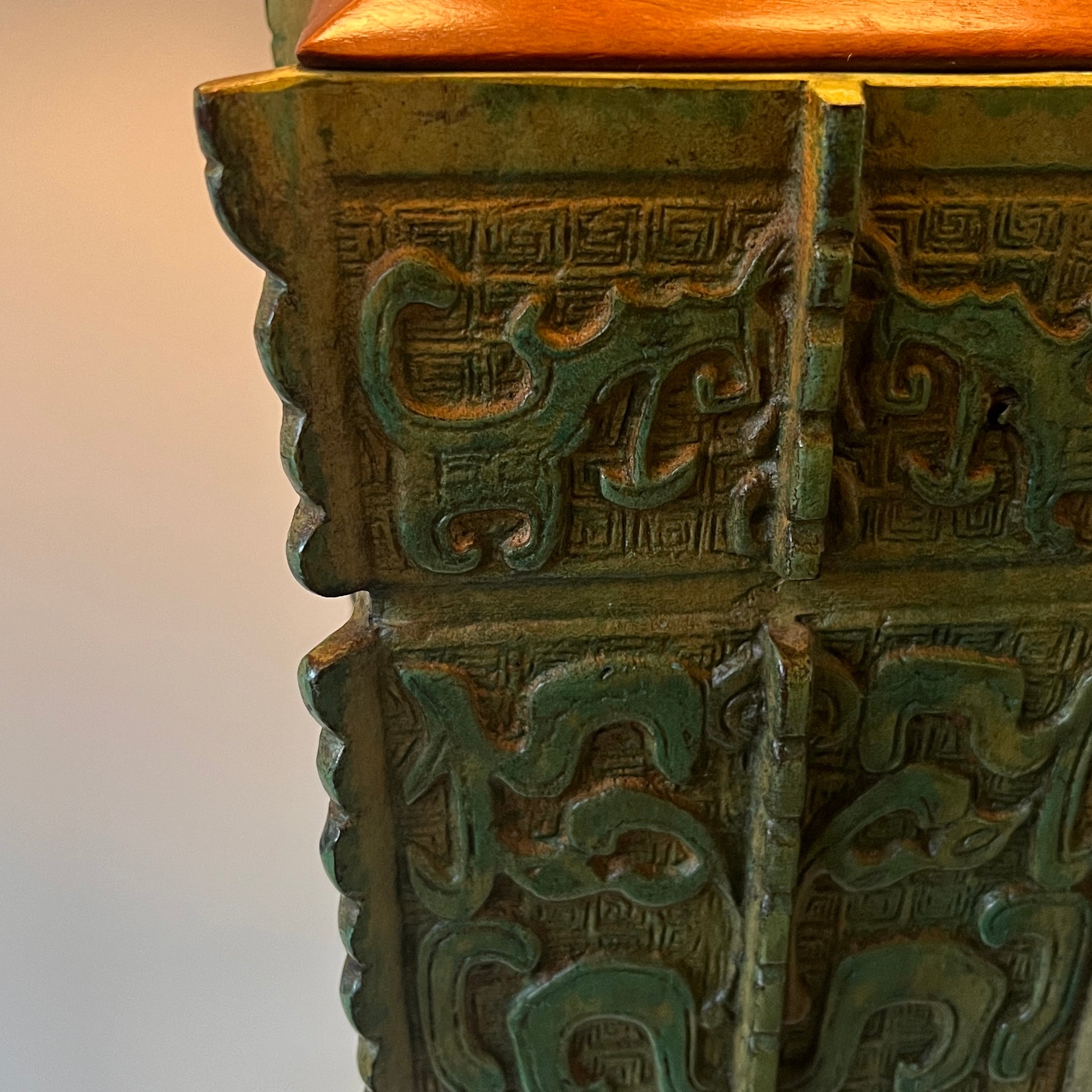 green Chinese archaic lamp base a neutral background