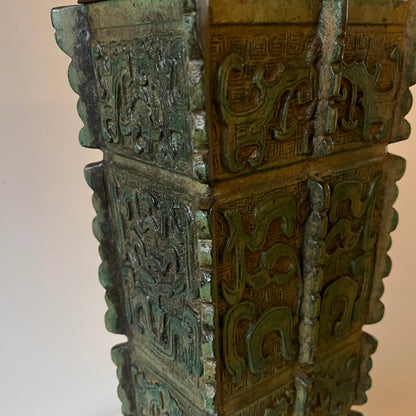 green Chinese archaic lamp base with a neutral background