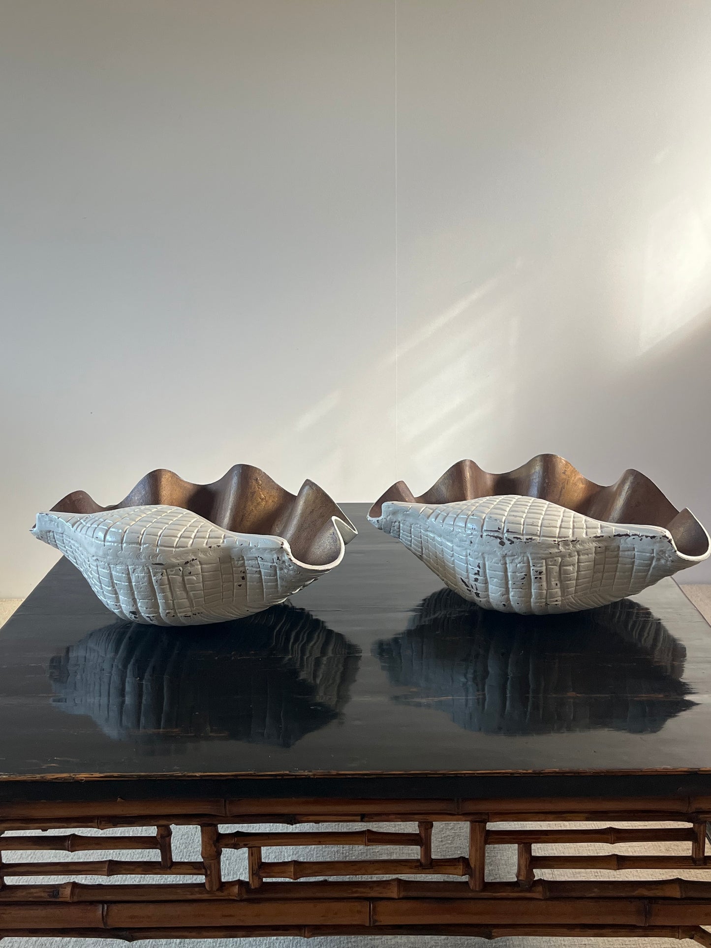 2 planters in the shape of clam shells on a brown table with a neutral backround