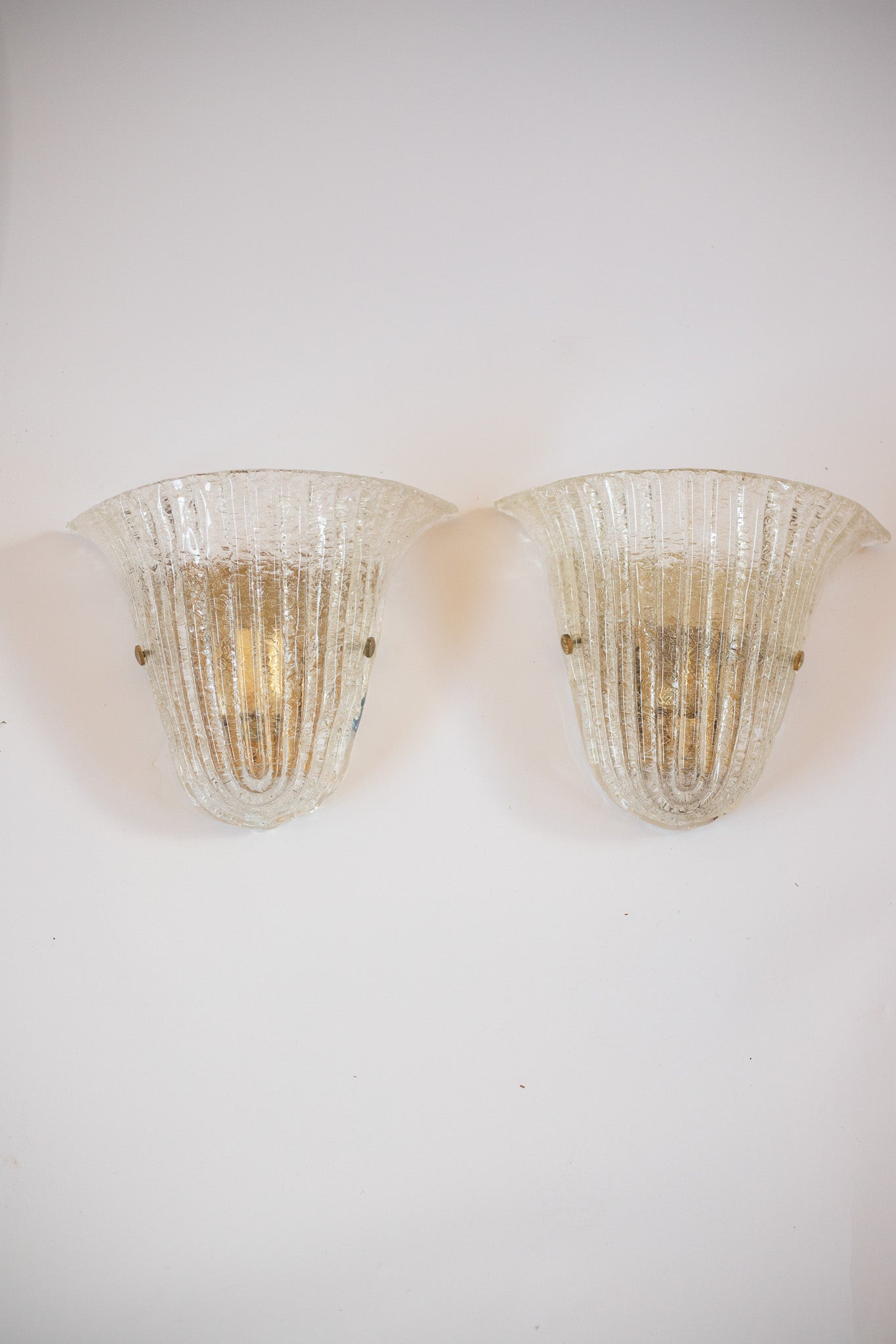 Two vintage-style wall sconces on a white wall. Murano glass Barovier and Toso