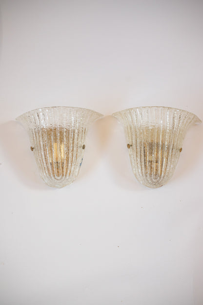 Two vintage-style wall sconces on a white wall. Murano glass Barovier and Toso