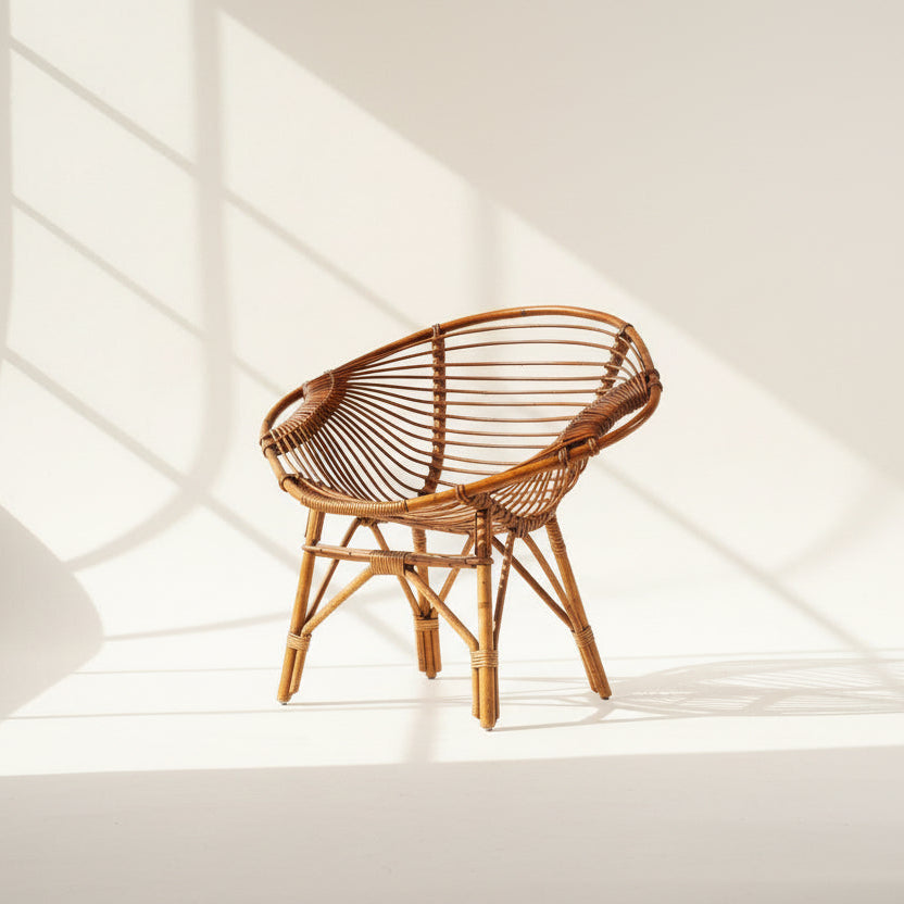 Wicker chair on a textured surface with a plain background