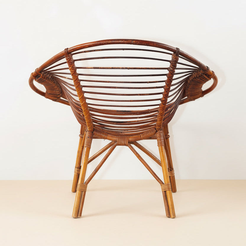 Wicker chair on a textured surface with a plain background