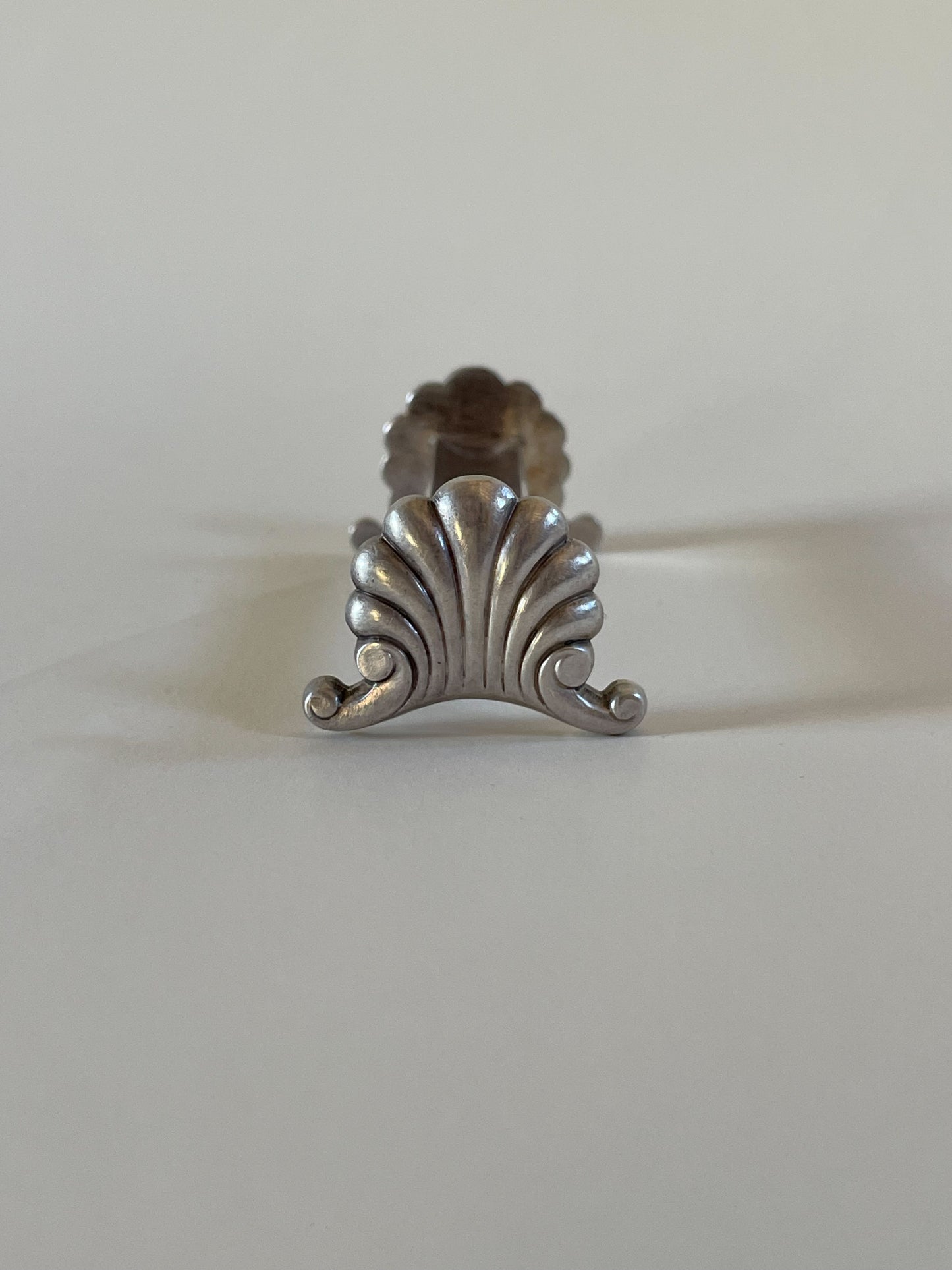 Silver knife rests on a neutral background
