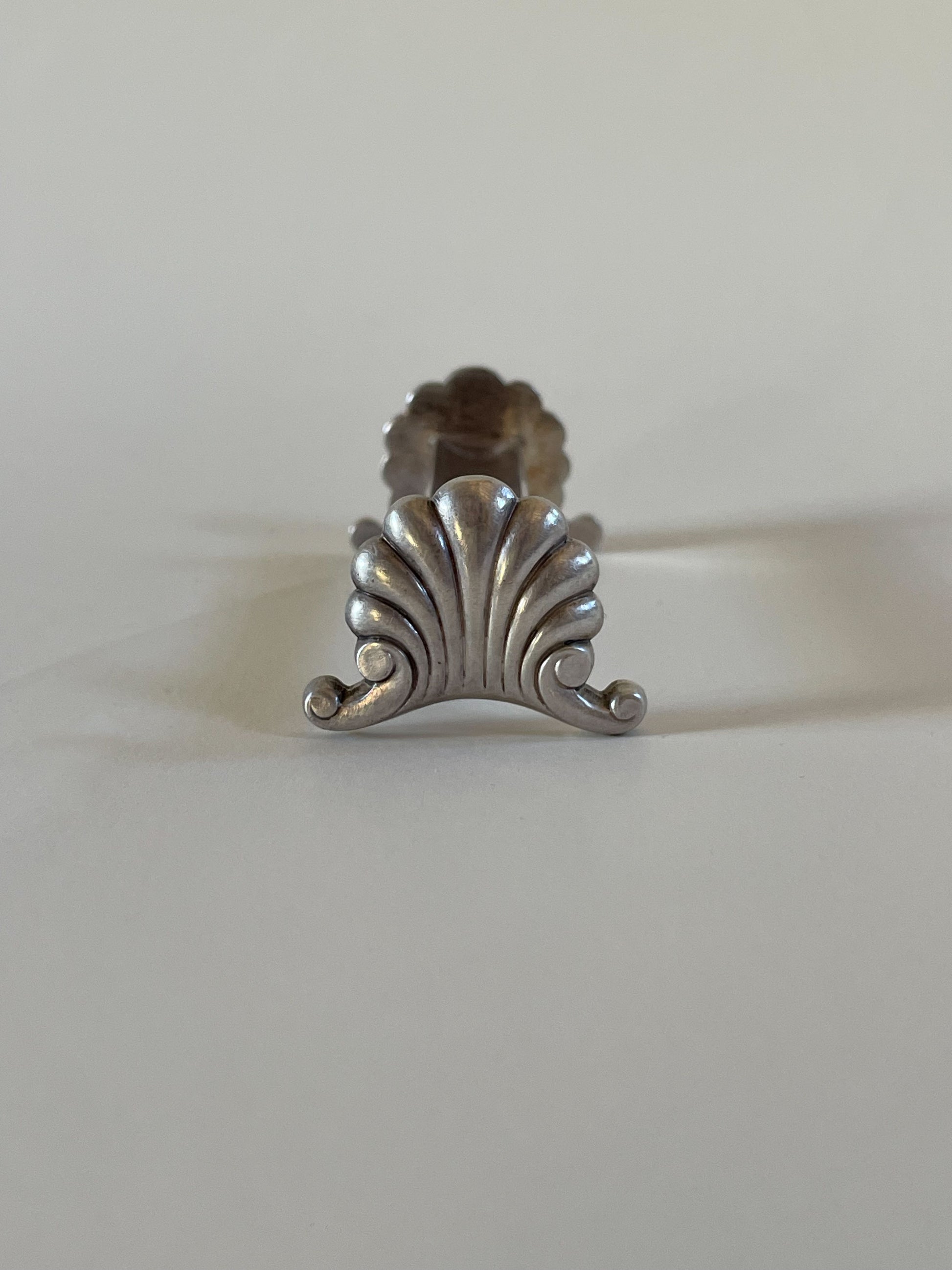 Silver knife rests on a neutral background