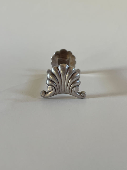 Silver knife rests on a neutral background