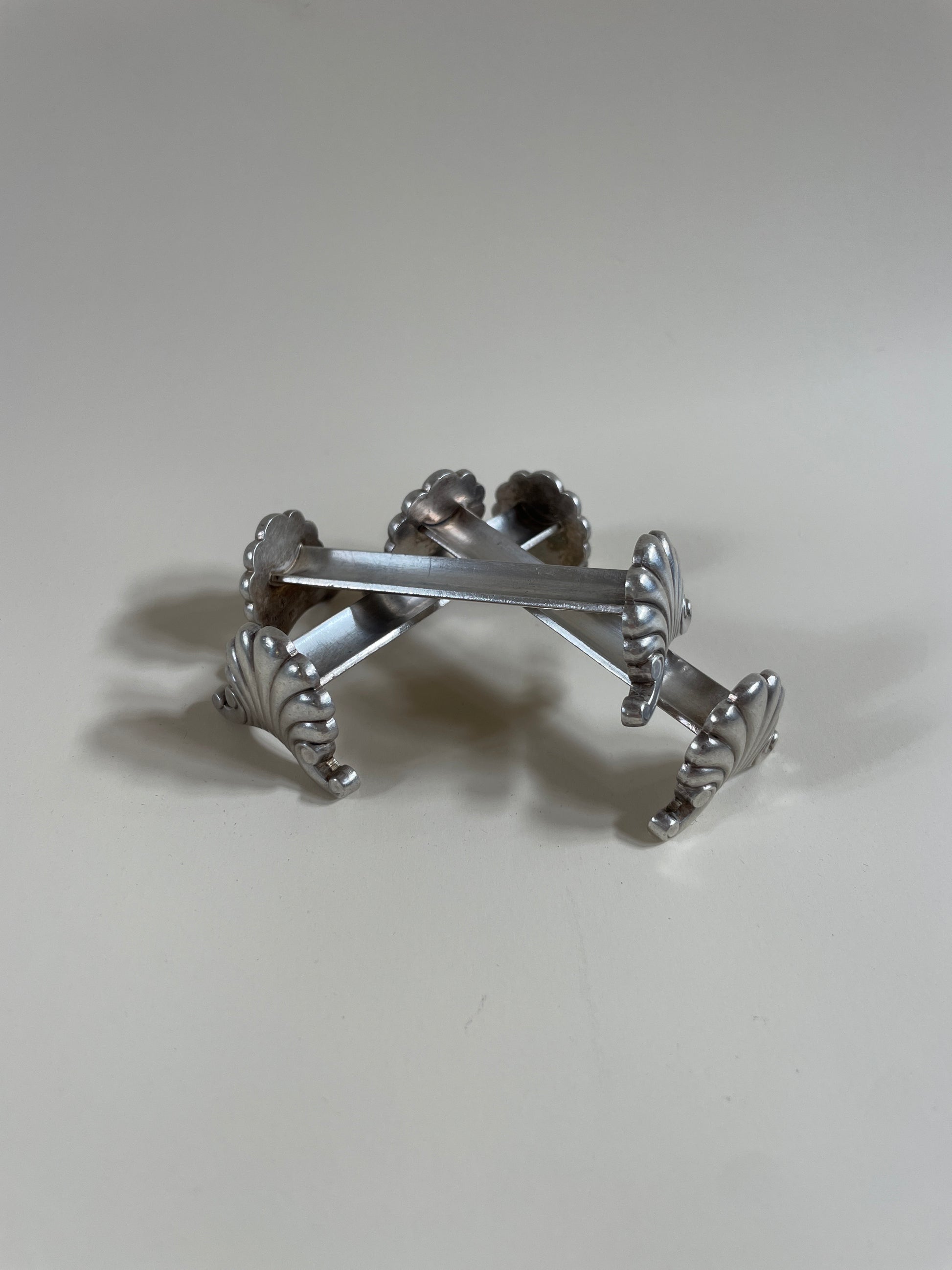 Silver knife rests on a neutral background