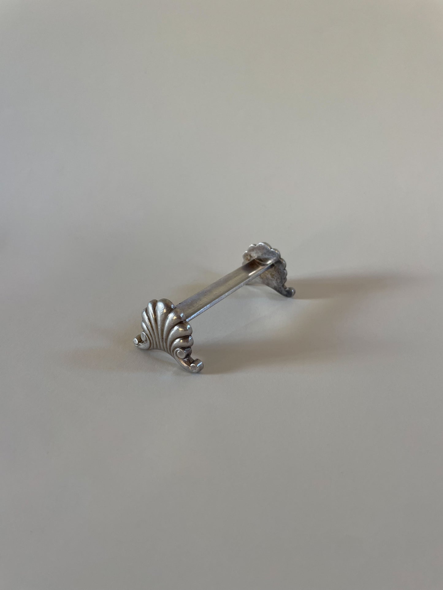 Silver knife rests on a neutral background