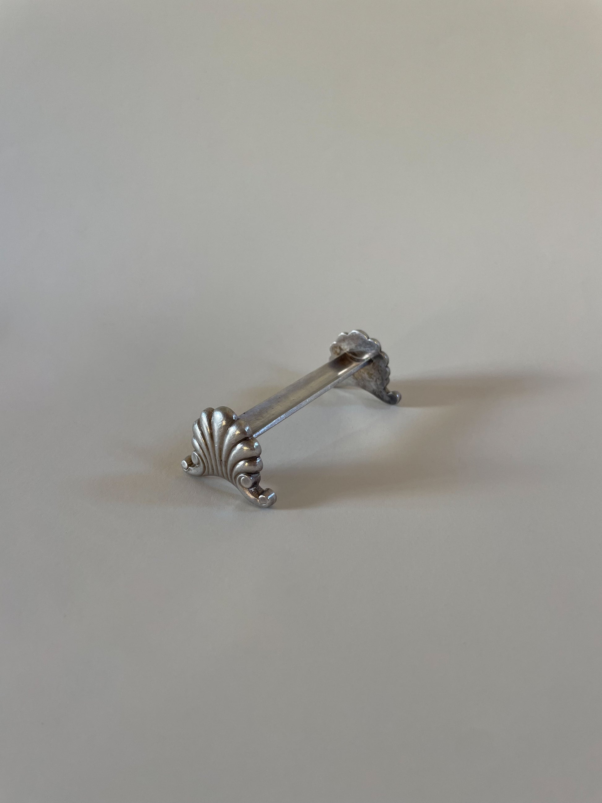 Silver knife rests on a neutral background