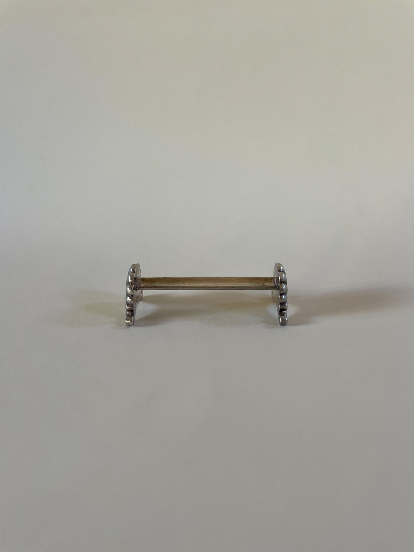 Silver knife rests on a neutral background