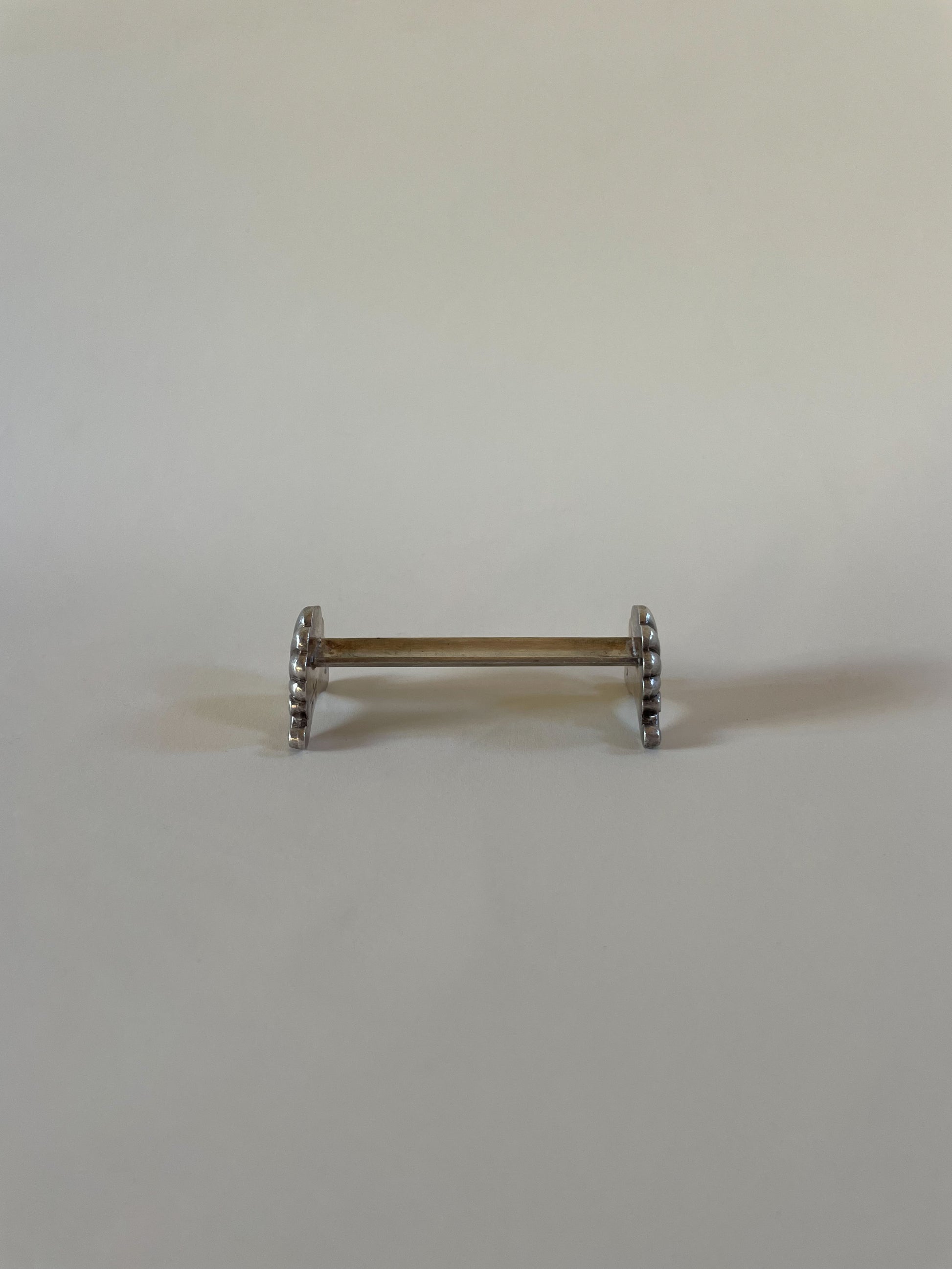 Silver knife rests on a neutral background