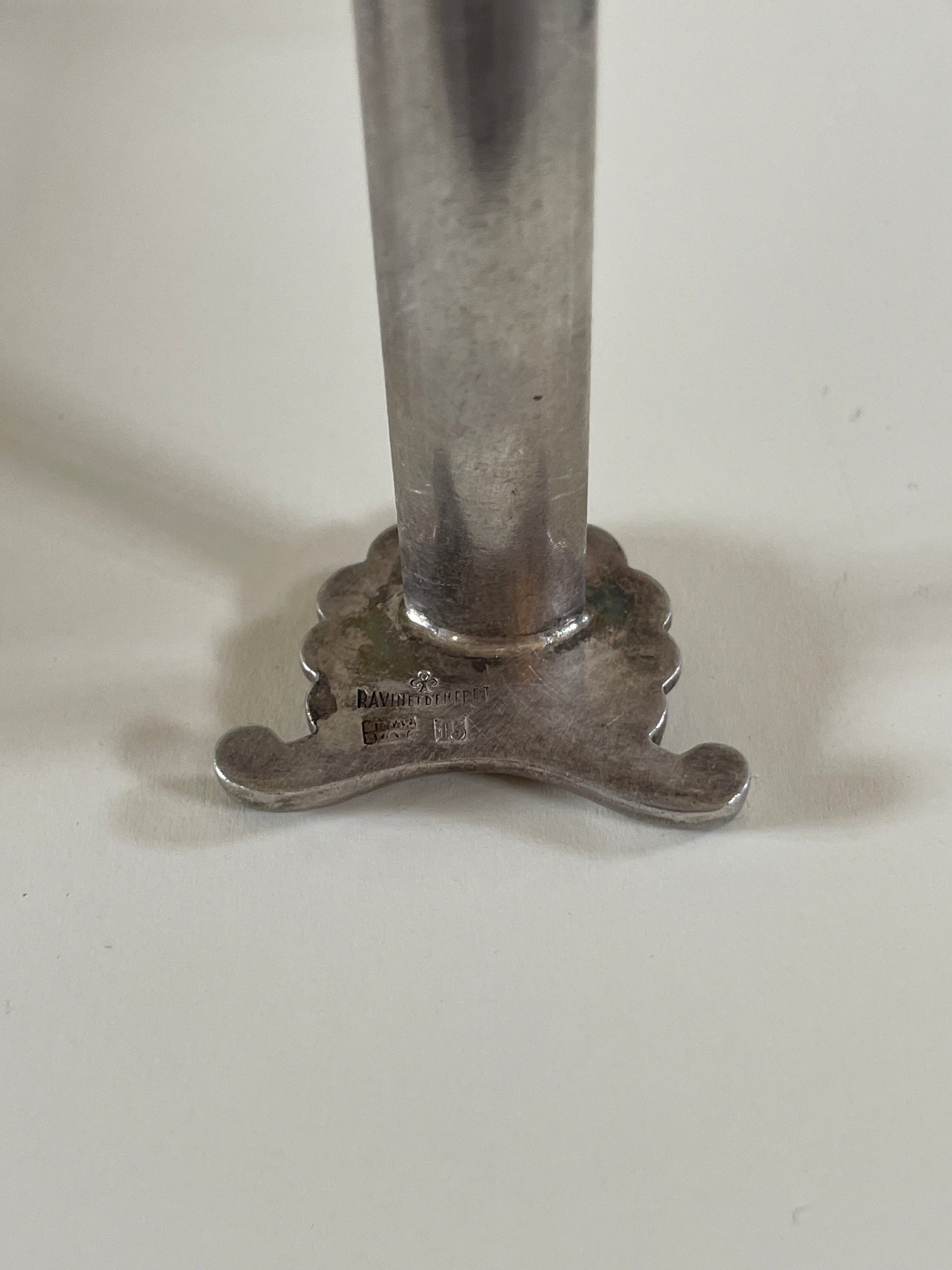 Silver knife rests on a neutral background