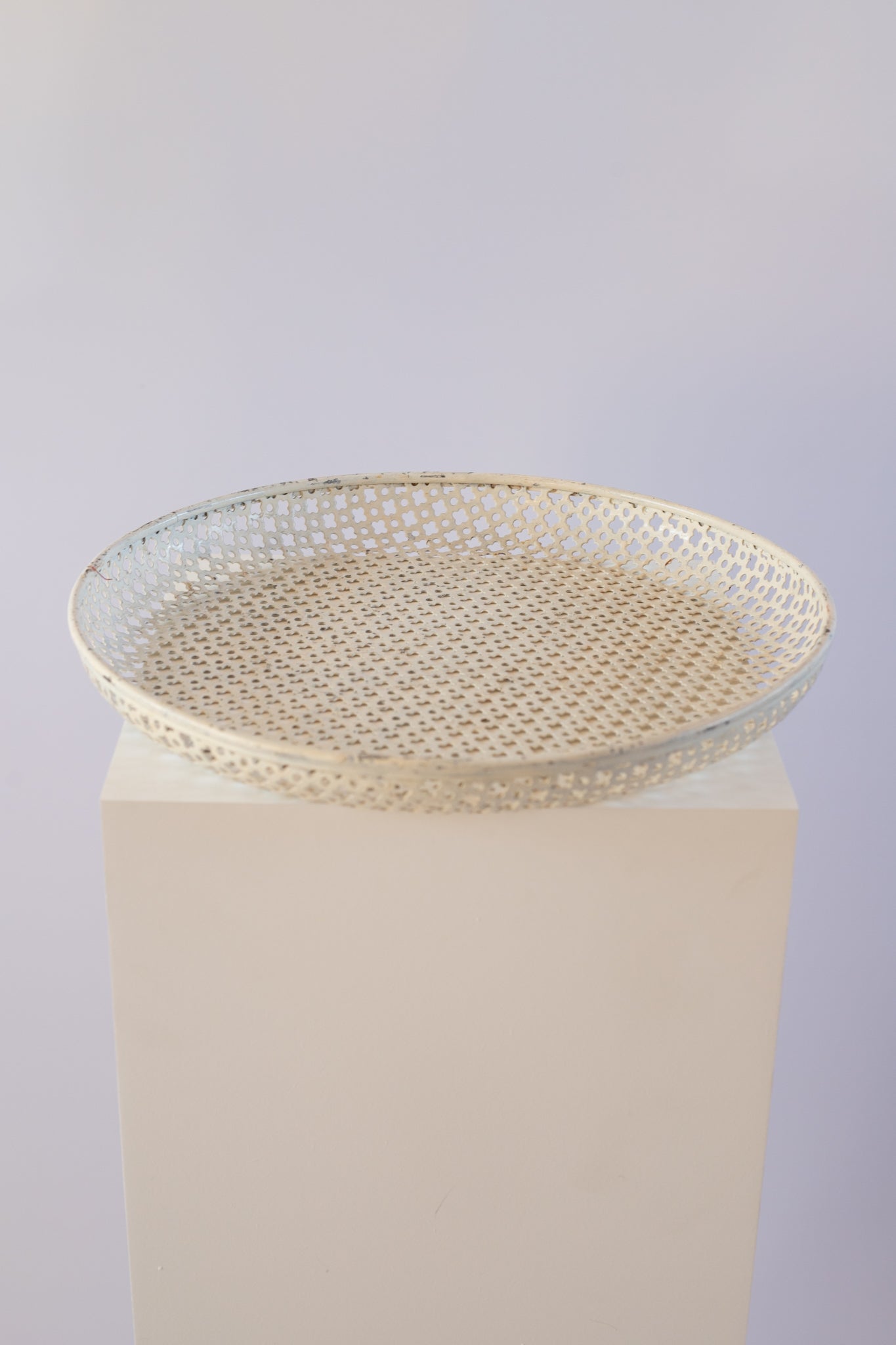 cream metal tray on light grey background