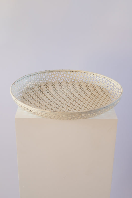 cream metal tray on light grey background