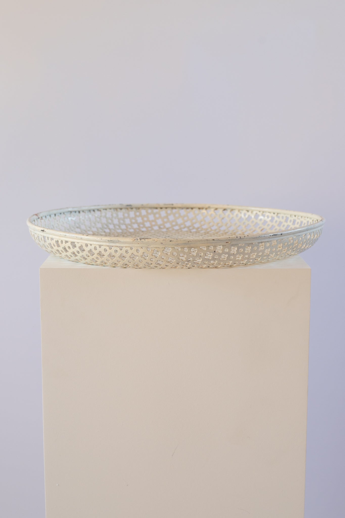 cream metal tray on light grey background