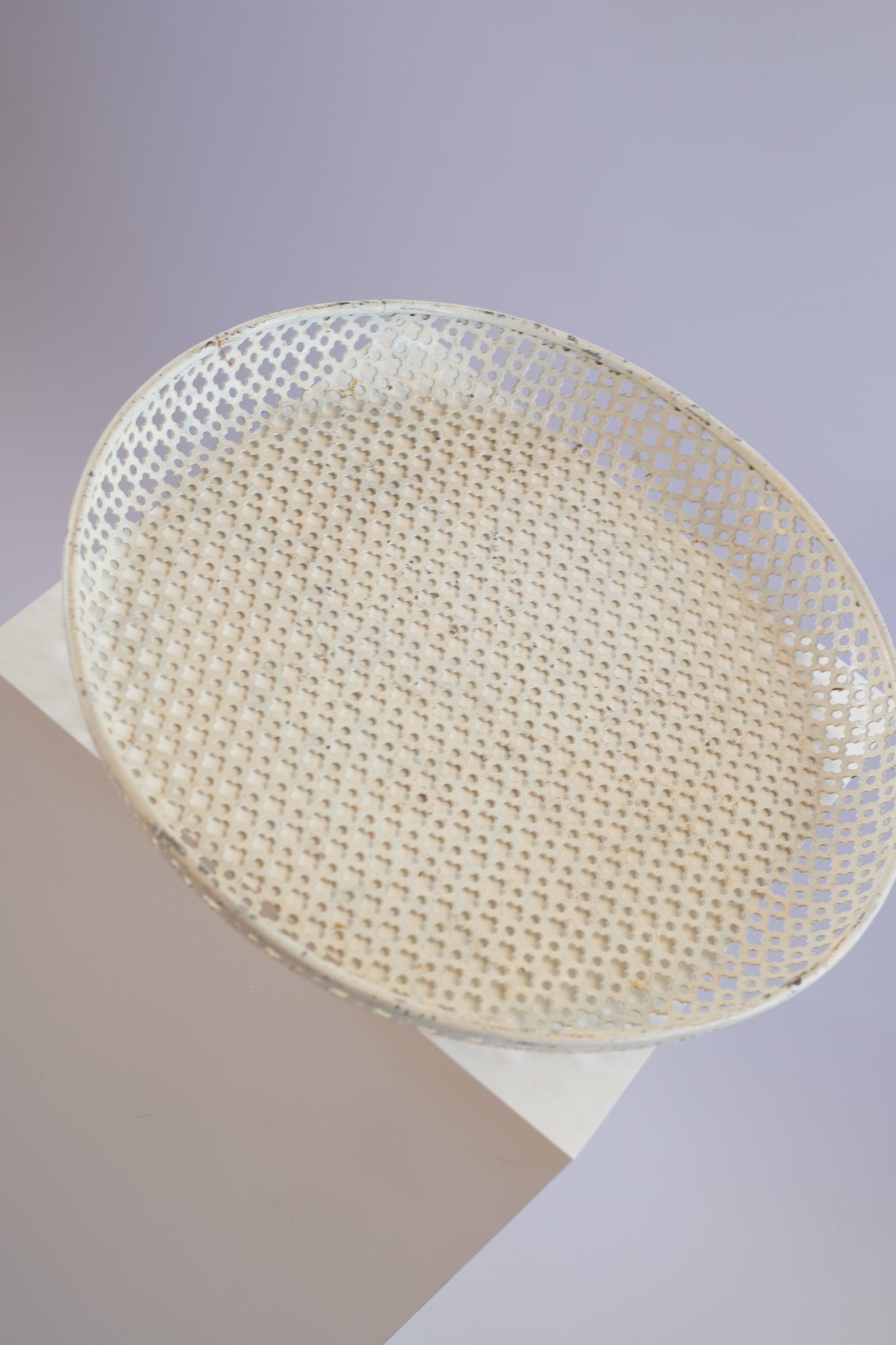 cream metal tray on light grey background