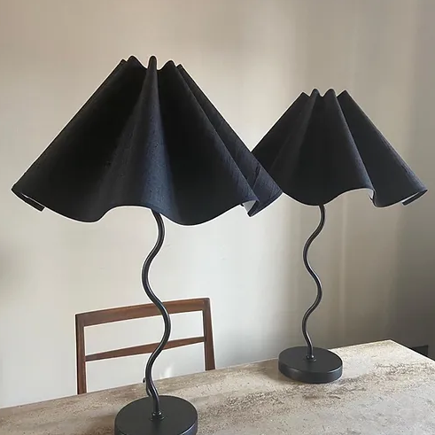 A pair of Maud Vaughan Wiggle Lamps placed next to each other on a table