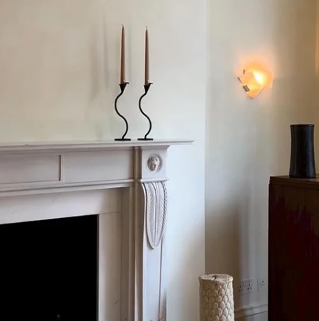 black iron wiggle candlestick on a mantelpiece 