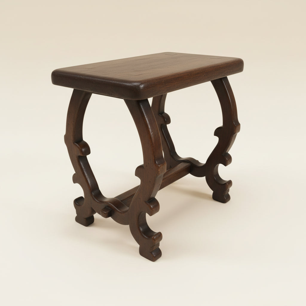 Wooden stool with intricate legs on a neutral background
