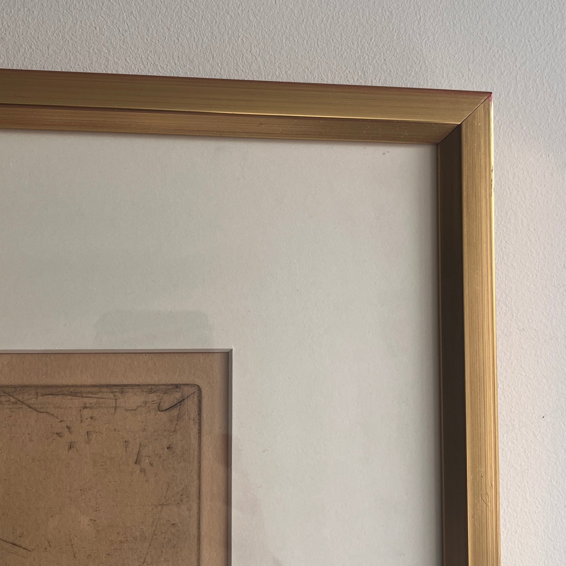 Ulf Trotzig Lithograph in a gold frame on a neutral wall